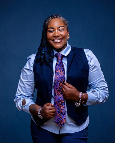 Personality-driven branding headshot with deep navy studio backdrop — RedHed Photography, Tallahasse