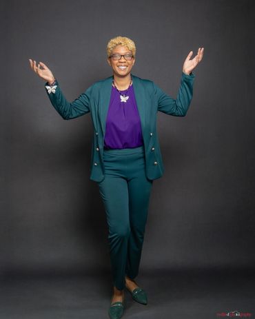 Full-length branding headshot with royal blue studio backdrop and lavender suit — RedHed Photography
