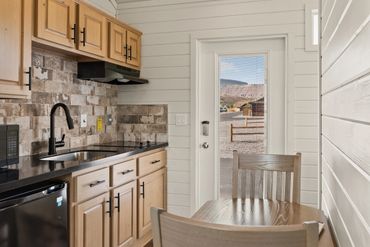 Cozy kitchen with wooden cabinets and a view through a glass door.