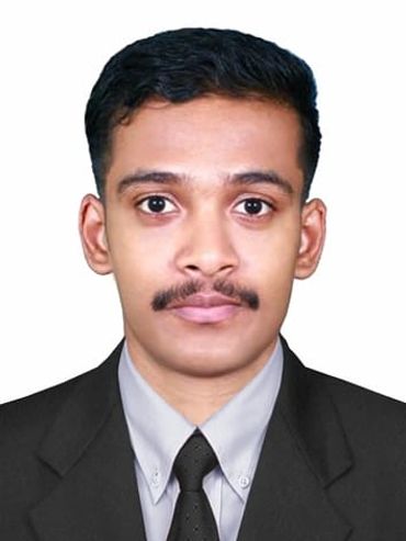 Portrait of a young man in formal attire with a neutral expression.
