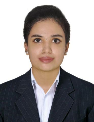 Professional woman in formal attire with a confident expression.