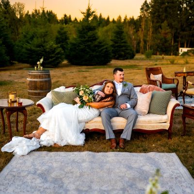Couple lounging on a vintage sofa in a meadow.
Photo copyright: Beautiful Feeling Photography.