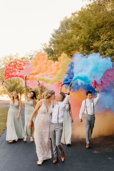 Wedding party with colored smoke bombs. Photo: C&B Photography. Venue: The Water Oasis, Newberg OR