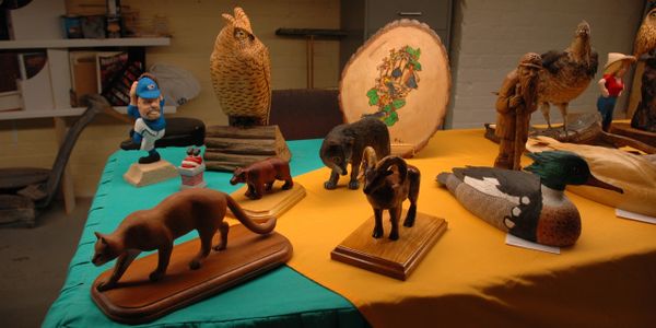 Various carvings and figures in soft lighting.