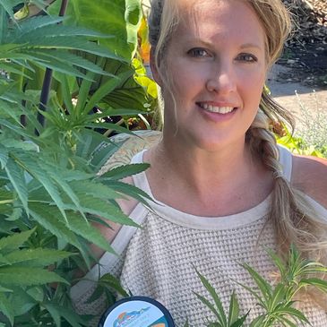A lady standing with green tree
