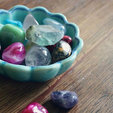 A bowl of healing crystals used during Reiki sessions.