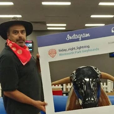 BullMan and the mechanical bull posing for an instagram framed photo for Friday Night Lightning at the Wentworth Park Greyhounds