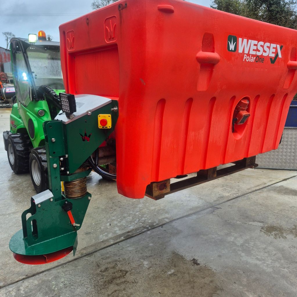 Green tractor with a large red Wessex PolarOne attachment.