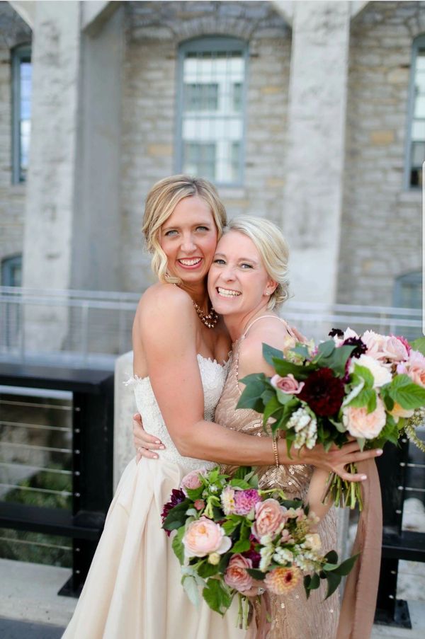 bride and bridesmaid embracing