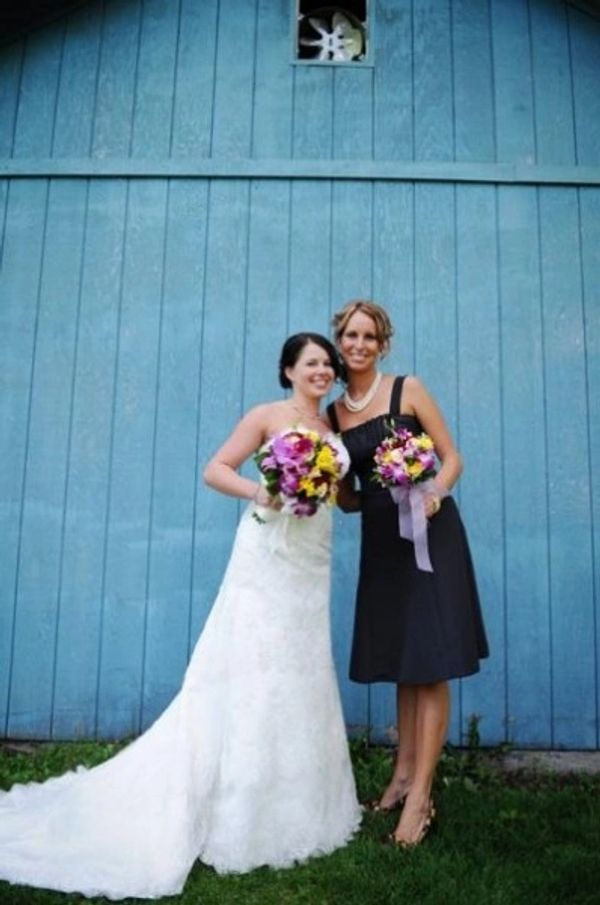 bride and bridesmaid holding flowers
