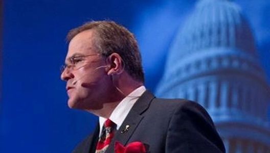 Side image of Roger Rickard speaking at a national conference.