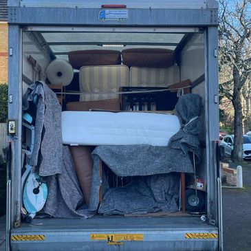 Moving truck loaded with furniture and household items.