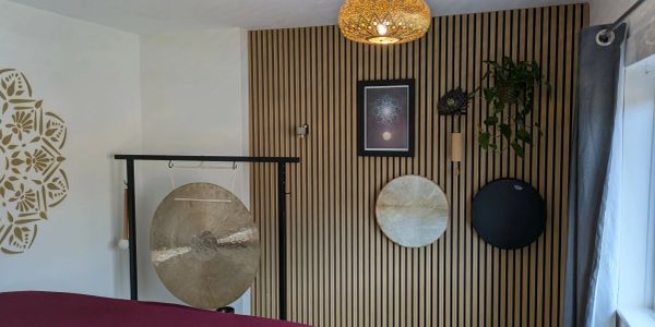 Our therapy room. There is a gong hung on a stand and two handheld drums hung on the wall.