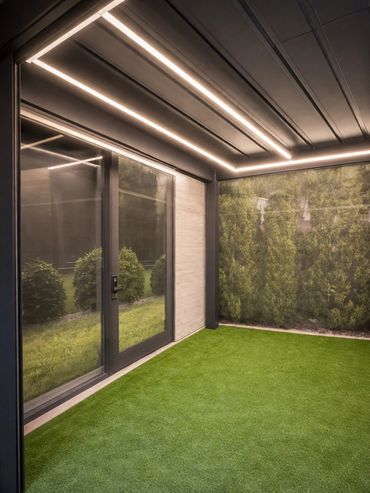 LED lighting inside modern louvered aluminum pergola.