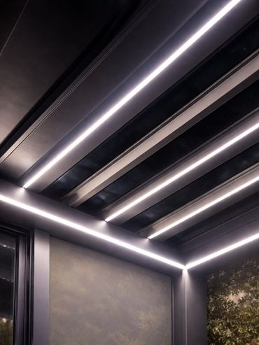 Modern aluminum pergola with integrated LED lighting detail.