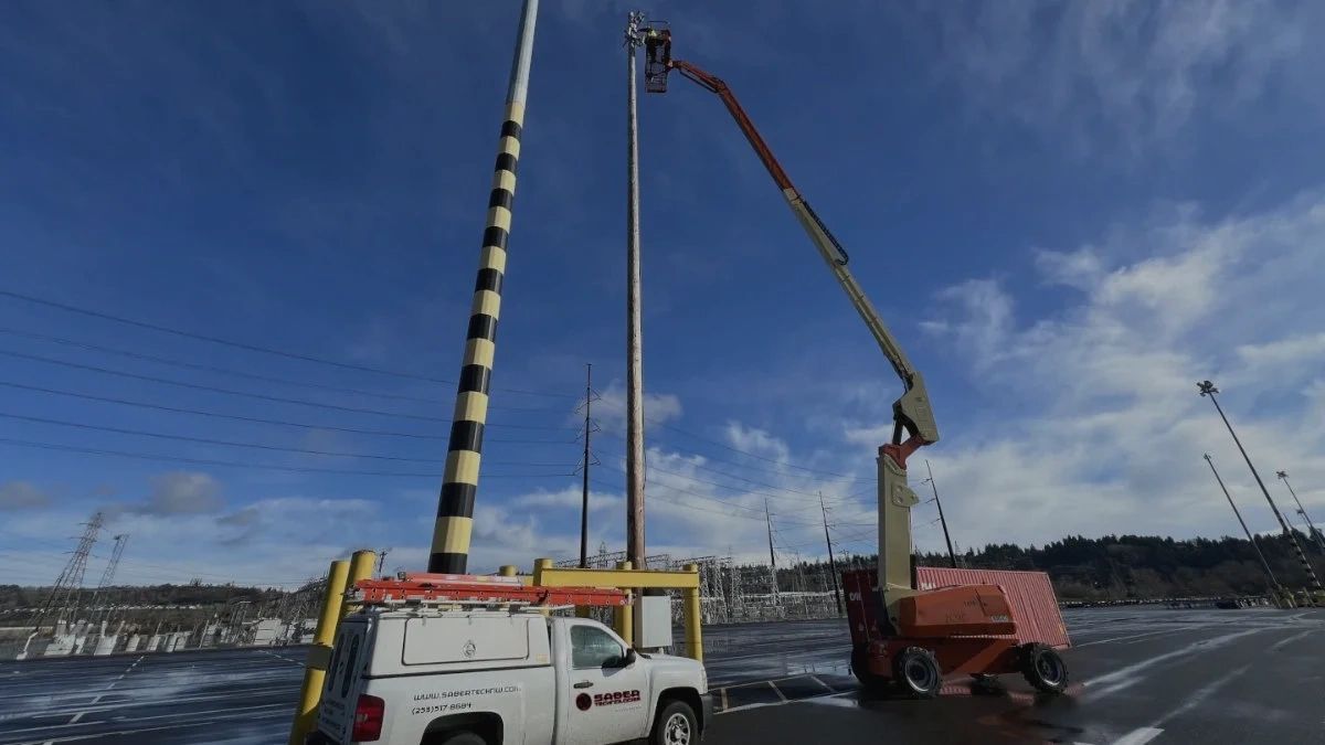 SABER Technologies truck and an individual installing an outdoor video surveillance camera