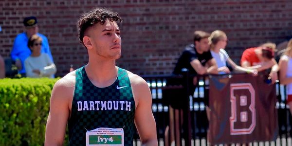 Athlete in Dartmouth uniform preparing for a track event.