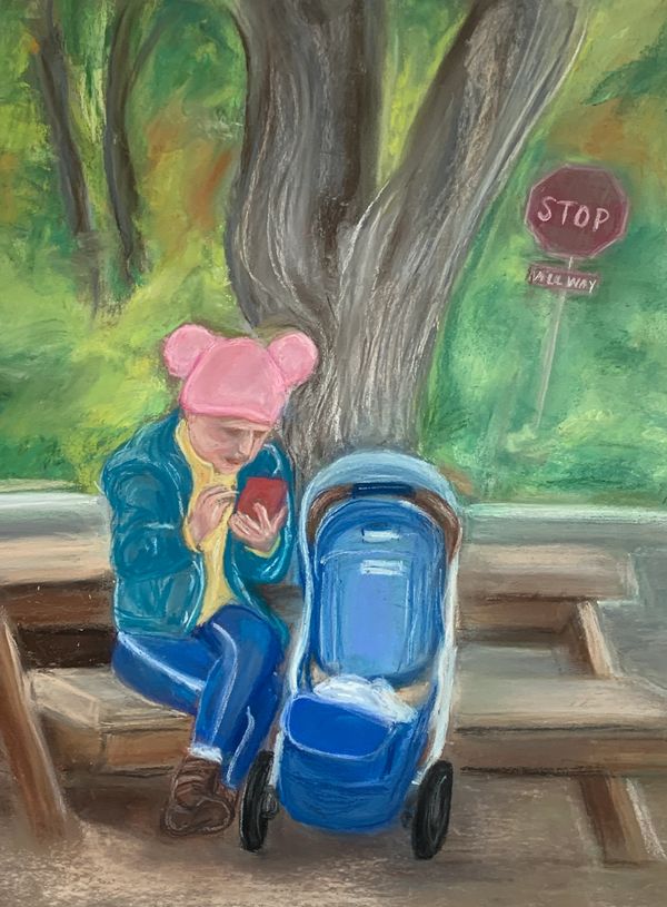 Woman wearing pink pussy hat sitting at a picnic table, stroller besides her, consulting cell phone.