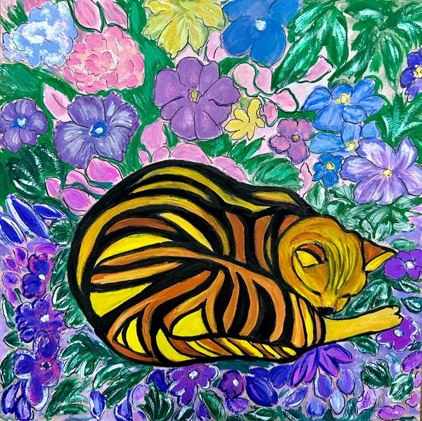 Striped cat sleeping in flower bed