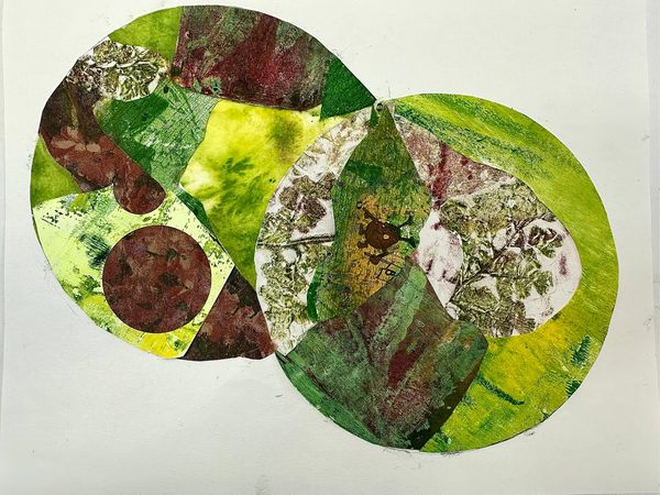 Two overlapping green circles with bits of botanic printed papers inside each