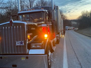 semi-truck in long traffic line
