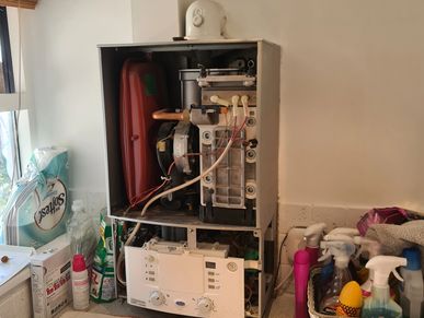 Heating engineer carrying out boiler repair and fault finding