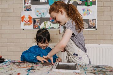 Children helping each other out in the printing process