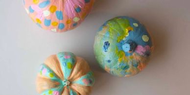 Group of colourfully painted pumpkins