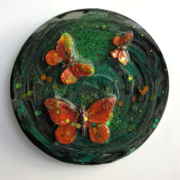 Orangey resin butterflies on green resin background