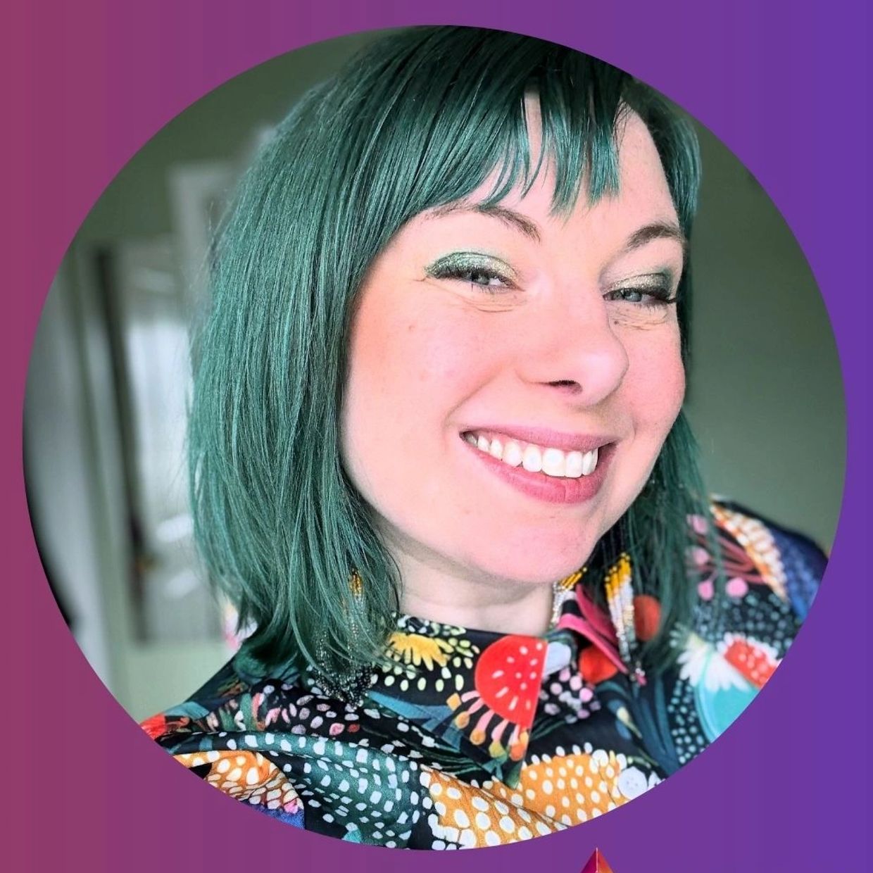 Smiling woman with teal hair and colorful floral shirt.