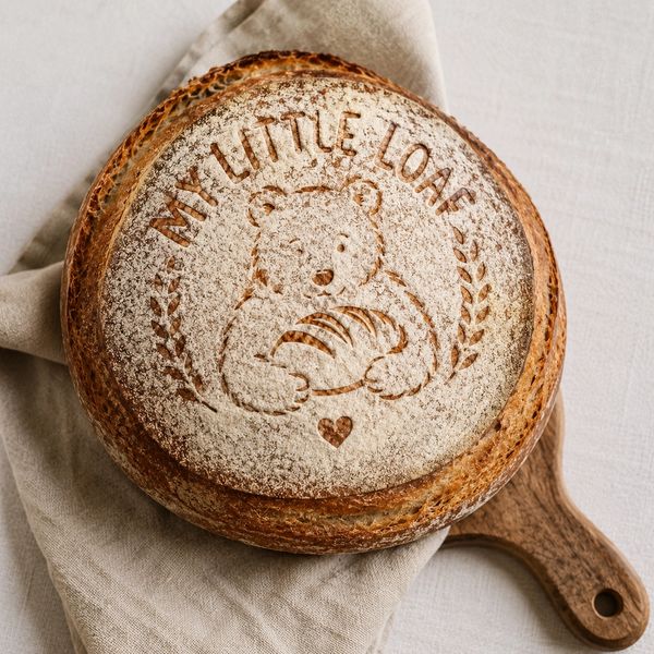 Round loaf of bread with bear design and text "My Little Loaf".