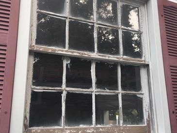 Before: original wooden window with peeling paint and no insulation