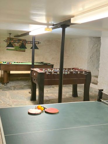 Full view of the games room from another angle, table tennis, table football and pool table.