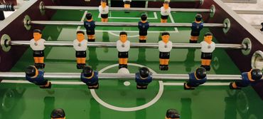 Close up action shot of table football in full play.