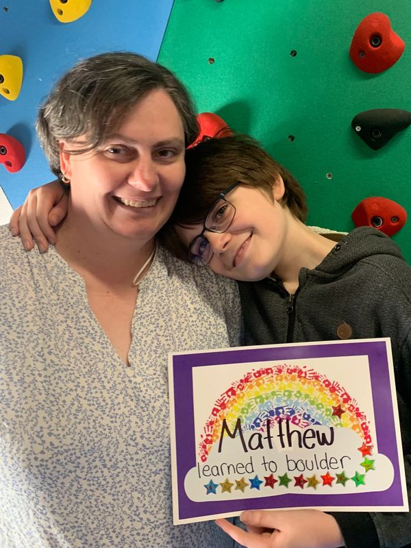 Kid learned to rock climb boulder in intensive physiotherapy