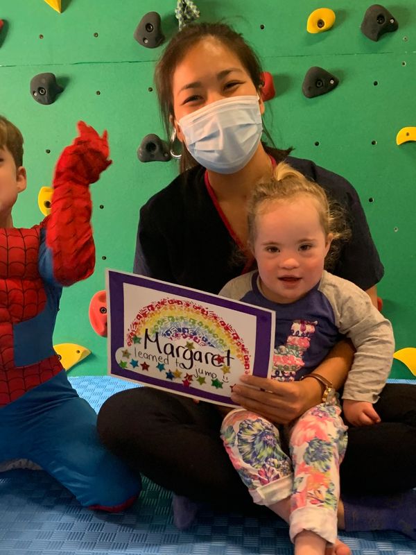 Kid learned to jump in intensive physiotherapy with physiotherapist