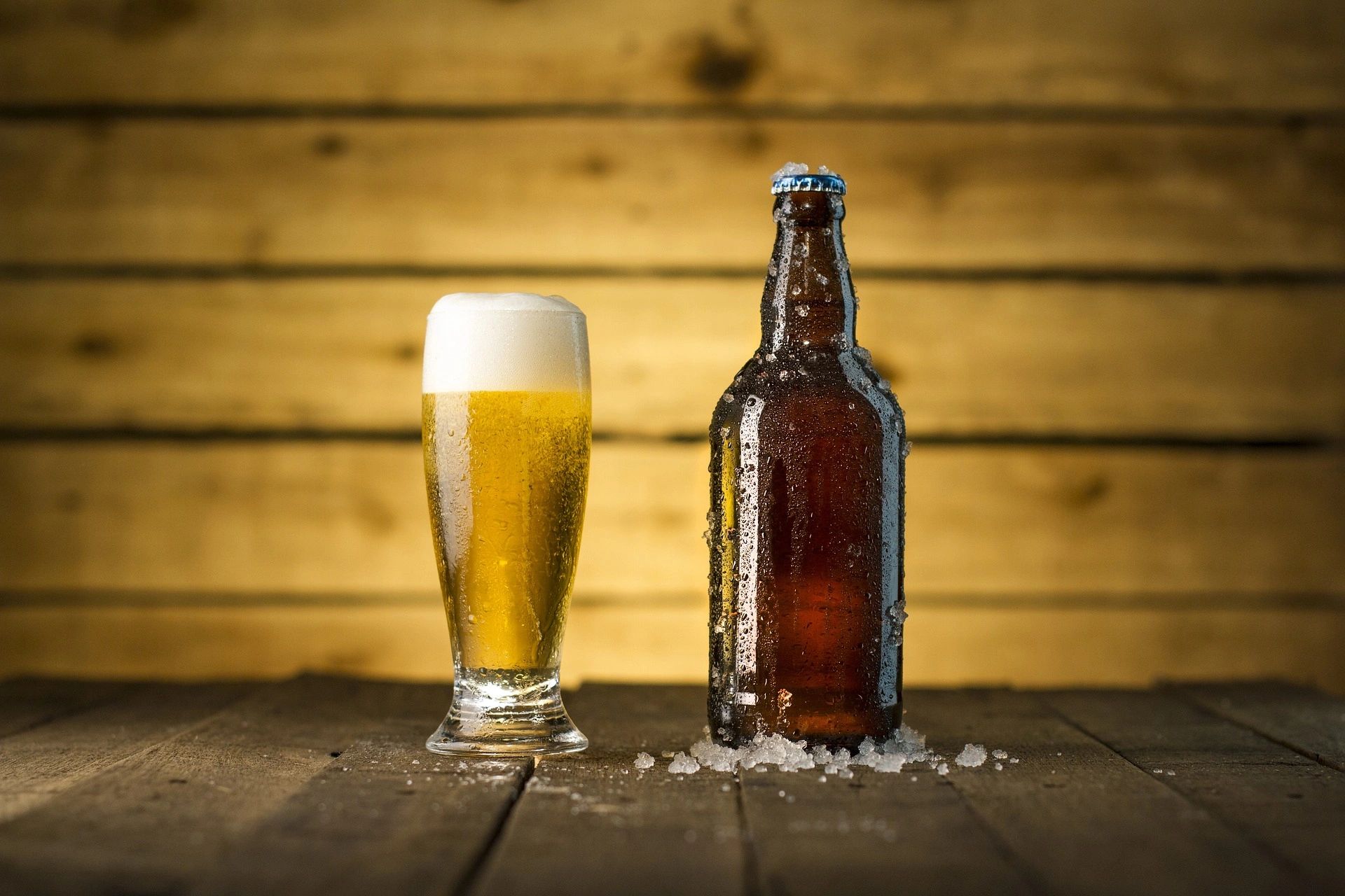 Glass of beer and bottle of beer on a table