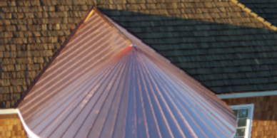 Radius copper roof with cedar shake roof and siding