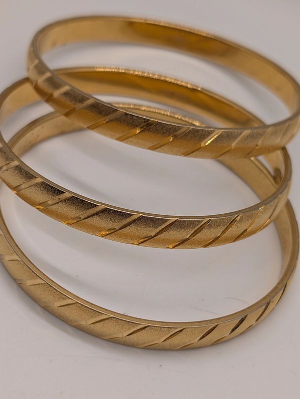 3 Gold tone bracelets