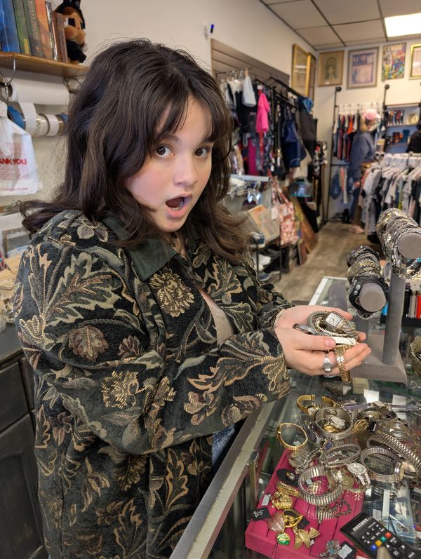Young lady holding watches in her hands.