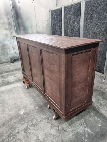 Handcrafted wooden cabinet on wheels.