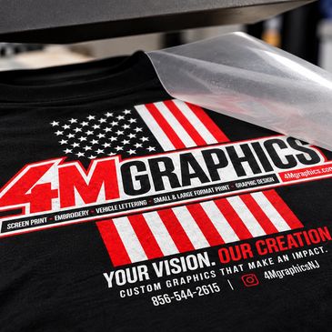 T-shirt with custom graphic design featuring an American flag and 4M Graphics logo.