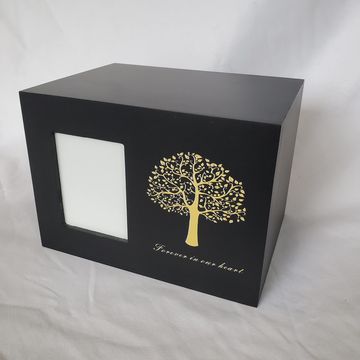 Black memorial box with golden tree design and photo frame.