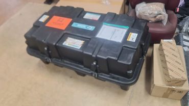 Large black plastic case with labels on top.