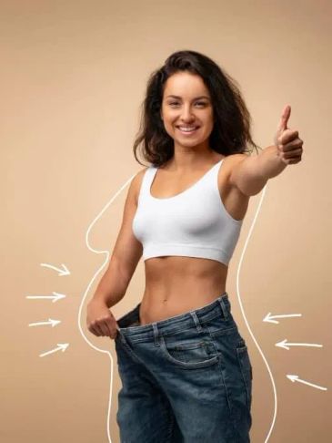 Woman showing weight loss and thumbs up.