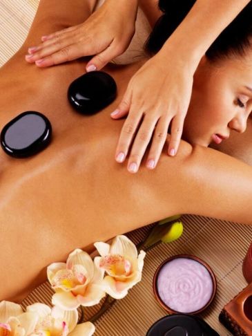 Woman receiving relaxing hot stone massage.