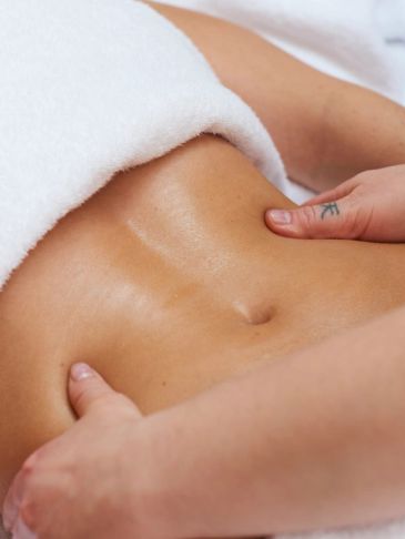 Person receiving an abdominal massage.