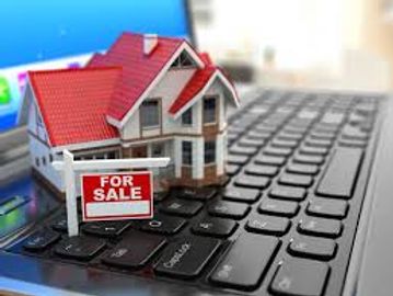 A picture of a model home on a laptop keyboard -home buyers starting point
