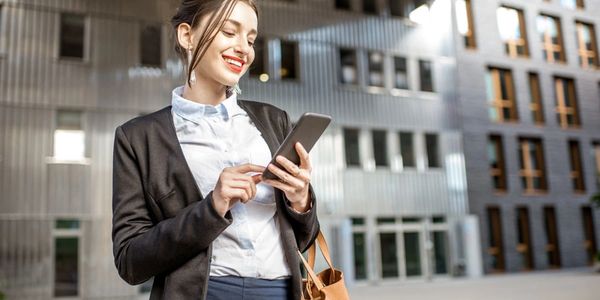 A photo of a confident realtor using AgentVoice to help her build her book of business