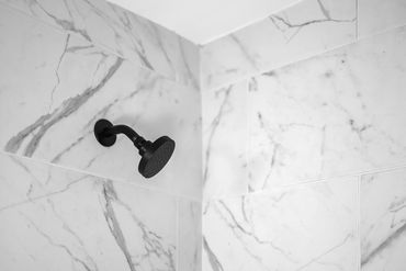 Custom rental property bathroom remodel by Rasnic Home Pros with modern fixtures